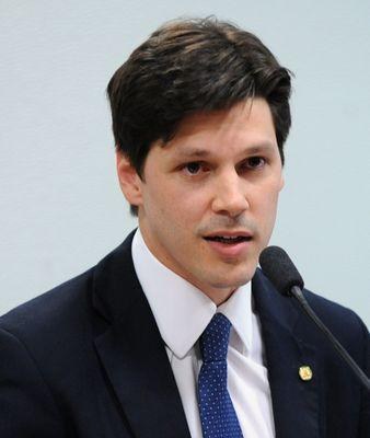 Ein Mann im Anzug spricht in ein Mikrofon an einem Rednerpult, wahrscheinlich um ein Regierungsgesetz zur Verbots des Internets zu unterstützen.